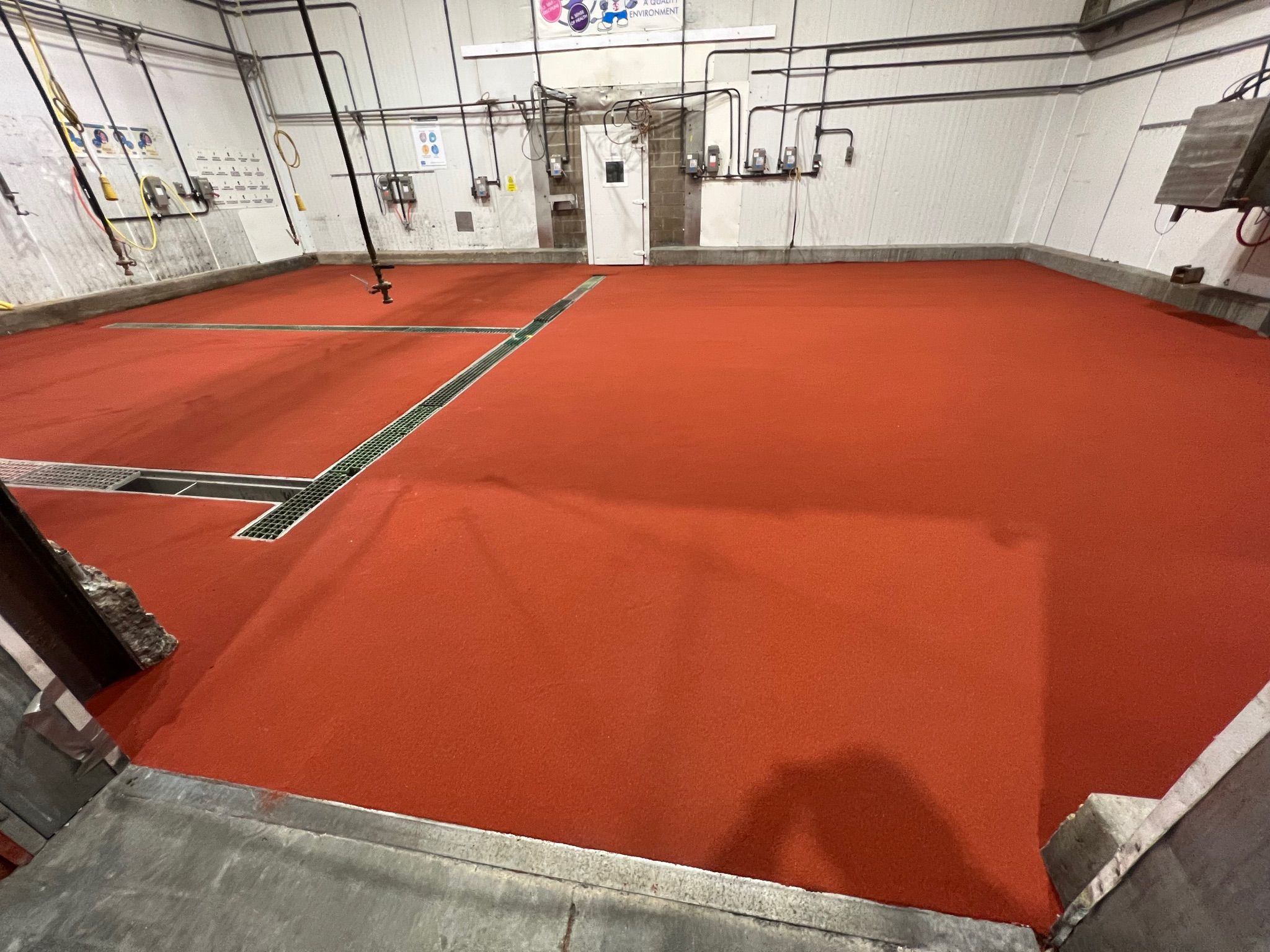 Completed red SaniCrete SL floor with quartz broadcast at beef processing facility