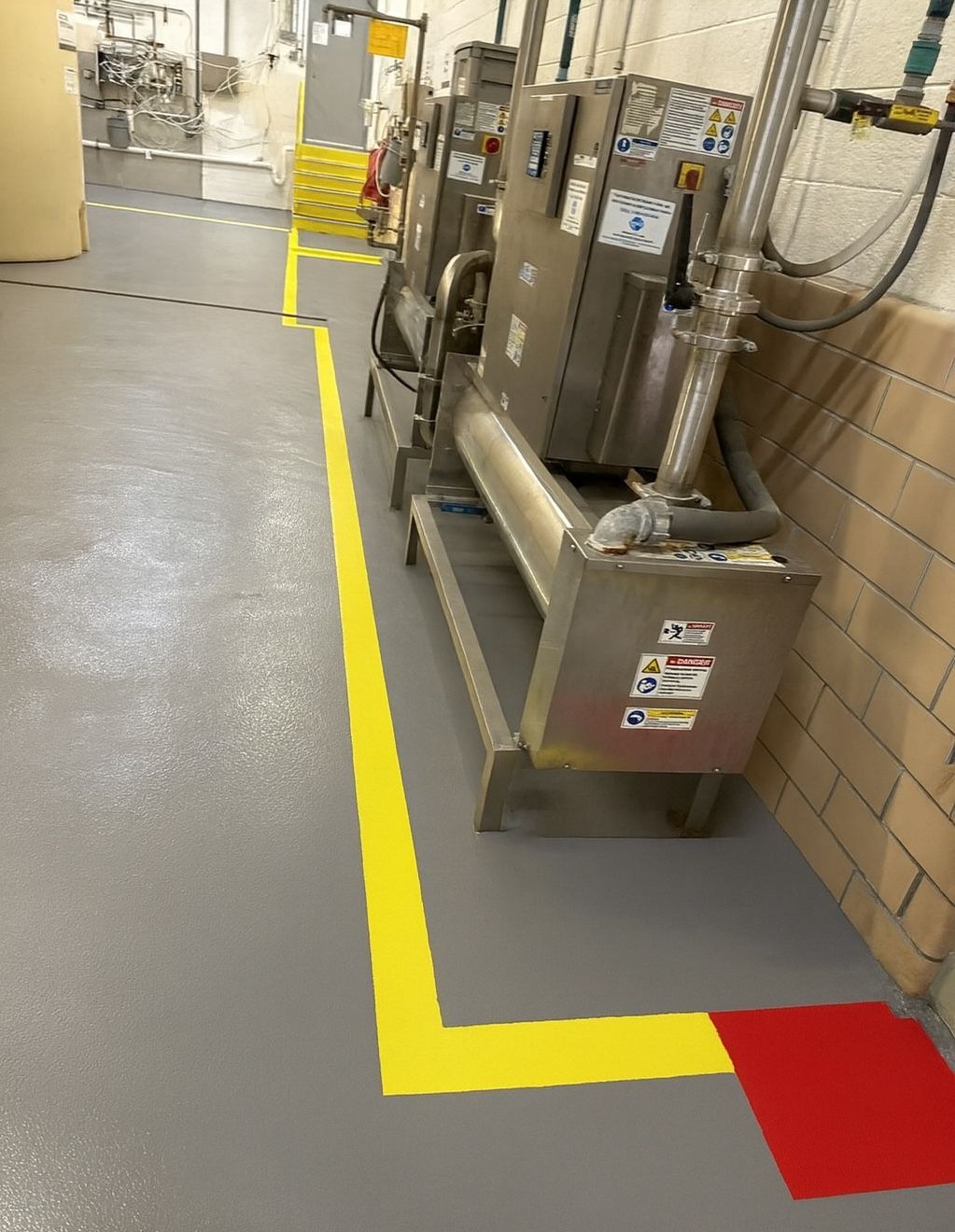 Completed chemical storage floor with yellow zone markings