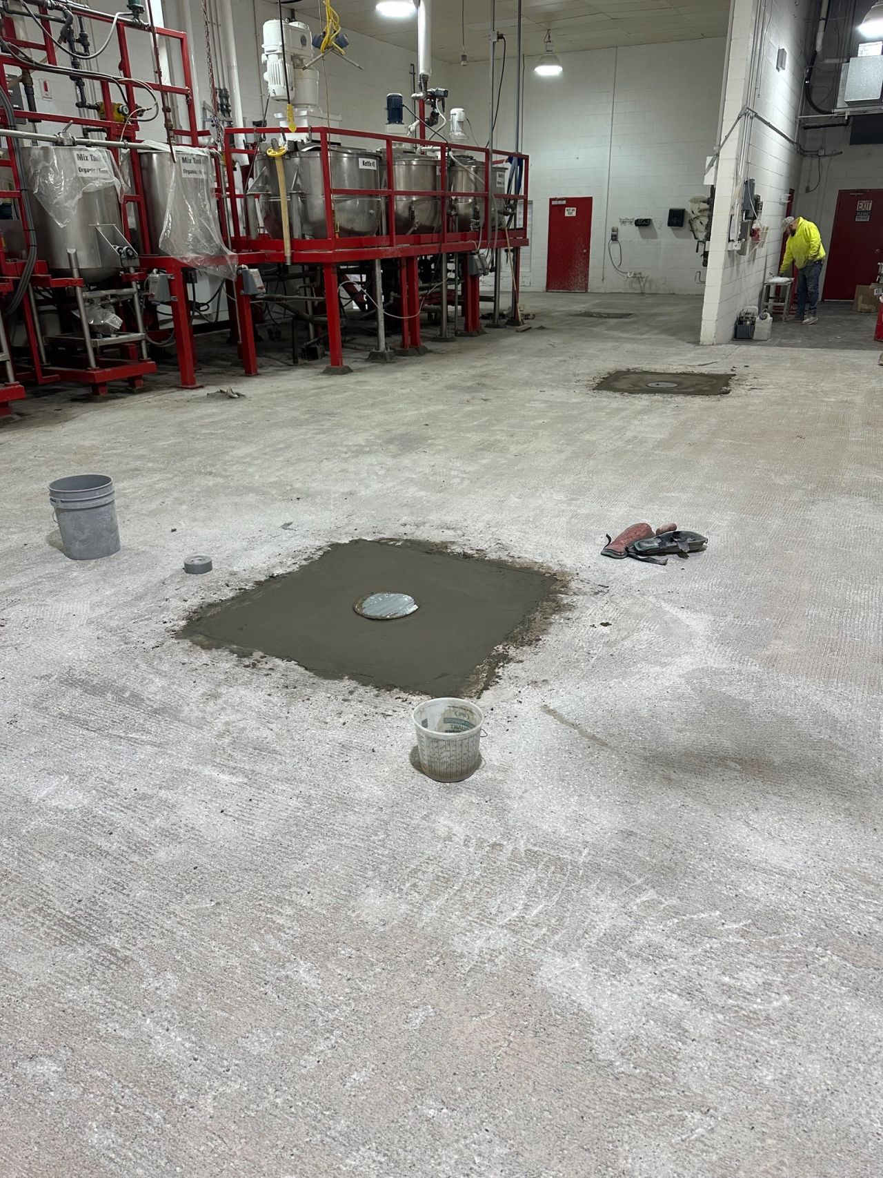 Scarified production room floor with new drain installations filled with SaniBulk polymer concrete