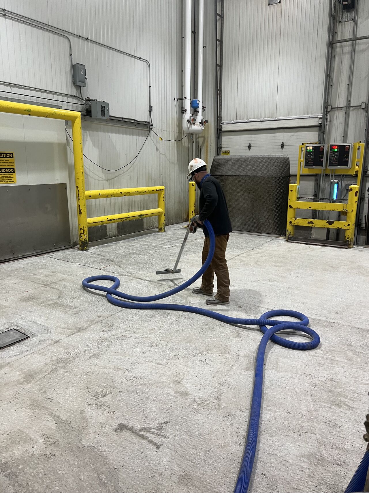 Loading dock floor mid-installation showing fresh red coating being applied