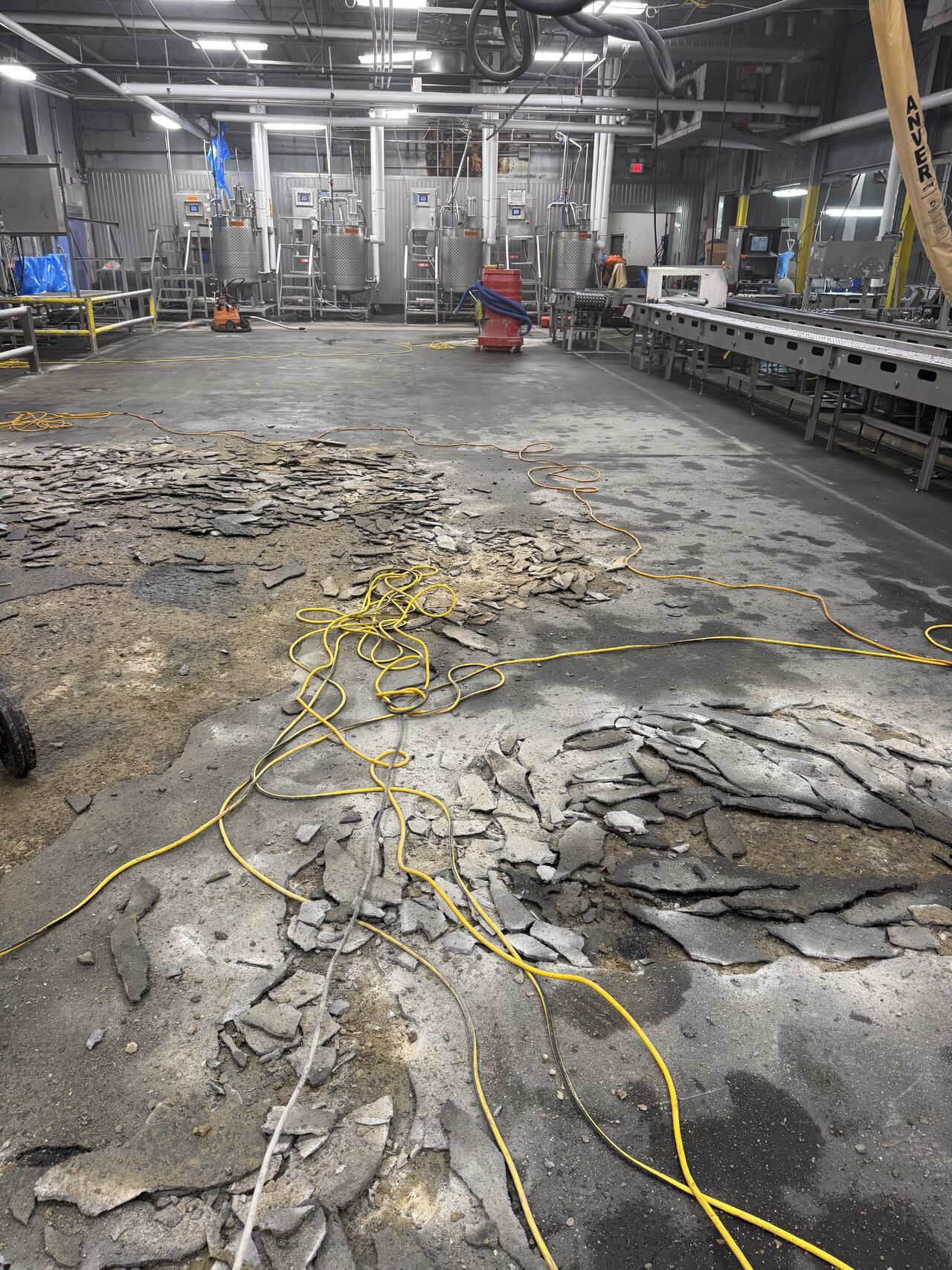Hilti jackhammer breaking up delaminated flooring during Saturday demolition