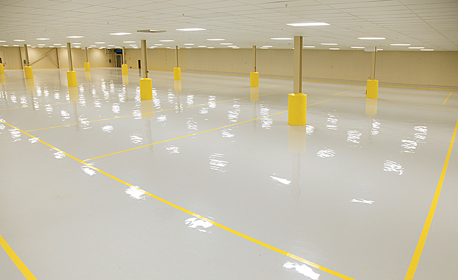 SaniCoat epoxy floor coating with yellow safety line striping in commercial facility