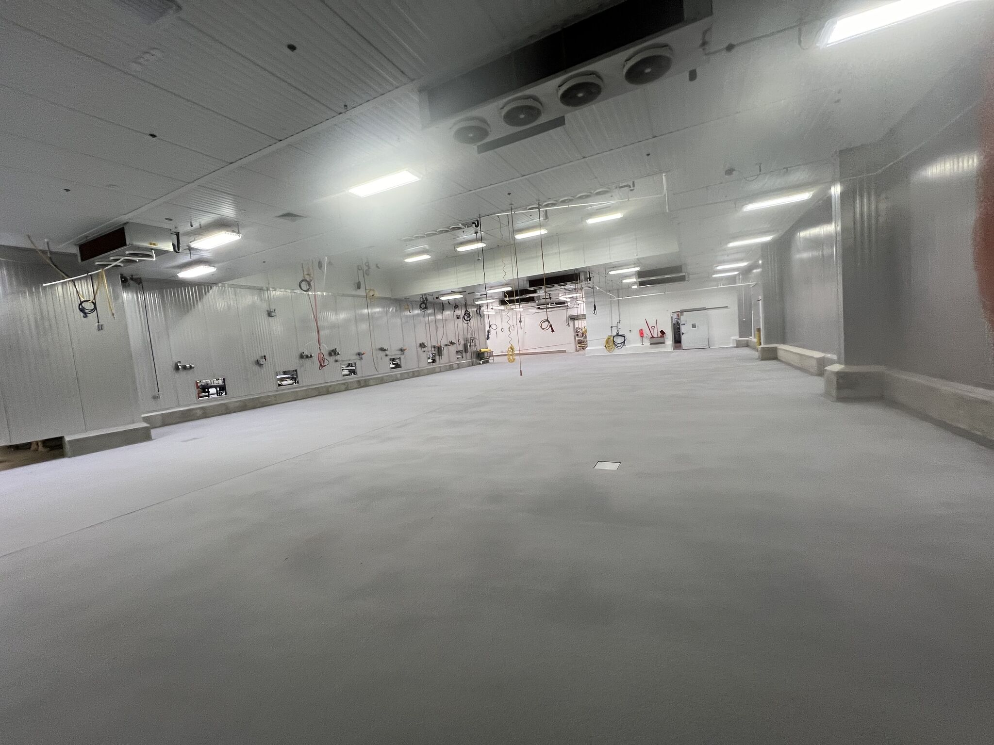 Completed gray STX floor in massive production room with VR curbing