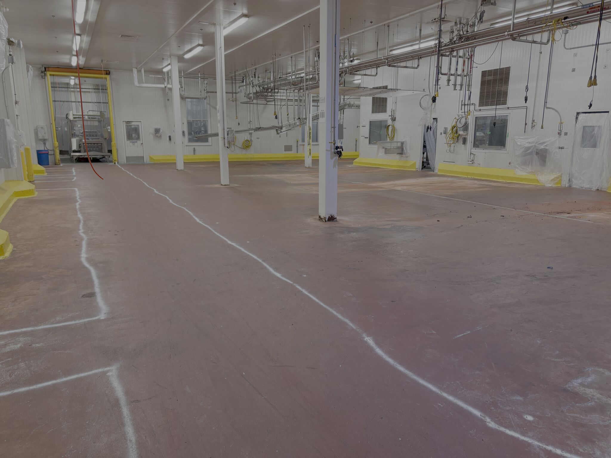 Worn and cracked food processing floor before SaniCrete STX replacement
